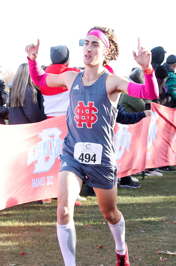 Senior Nik Davis kept pace with some of the state's top runners at last week's Class 4A district meet in Dubuque, and celebrated his seventh-place finish at the end of the race.