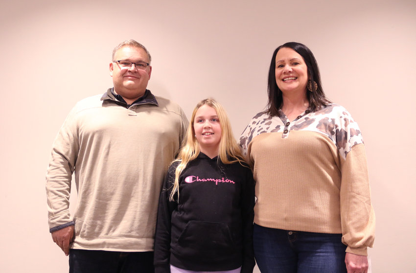 Eldridge Mayor Frank King poses with Big Brother Big Sister participants Brianna Prewitt and big sis, Laura Wiley at Monday's Eldridge council meeting.