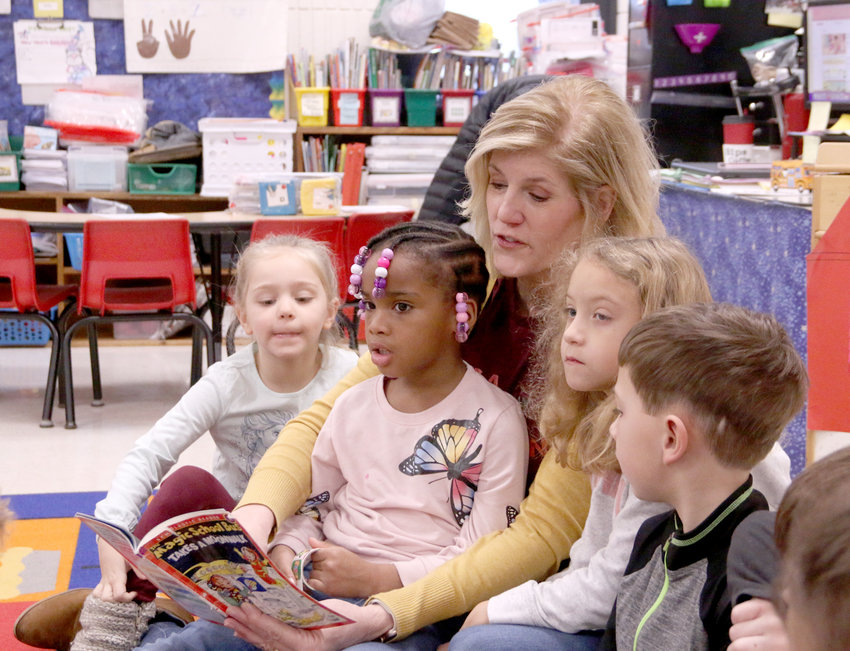 Armstrong Elementary kindergarten teacher Carolyn Lewis begins the day with reading to her class, including, from left, Ana Mayfield, Sa'Miyah Henderson, Lilac O'Hare Hicks and Bentley Glines.