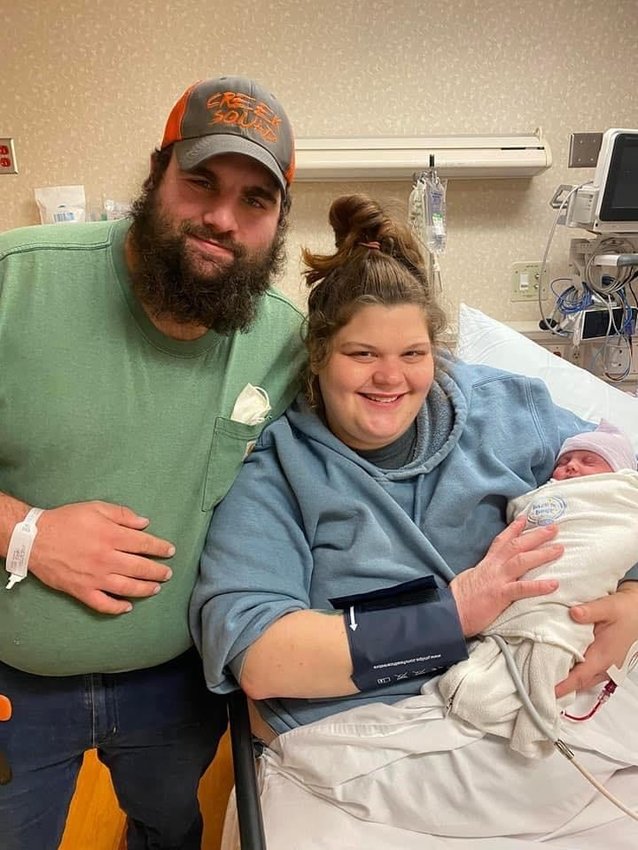 Edward and Katy Saunders hold their baby after Madeline was delivered on December 25