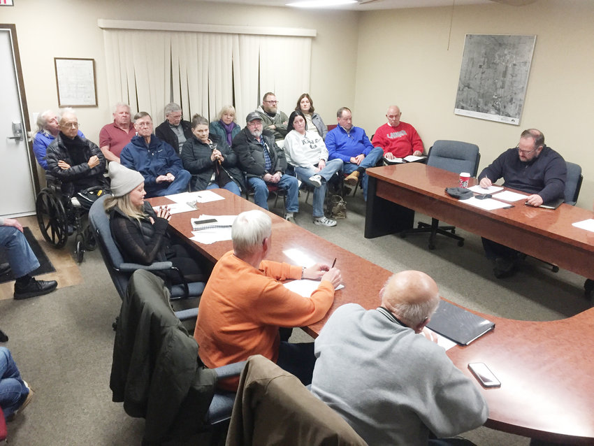 Ashley Atkins, center, asks Eldridge board of adjustment members for more time at a Jan. 31 meeting in Eldridge council chambers packed with her neighbors.