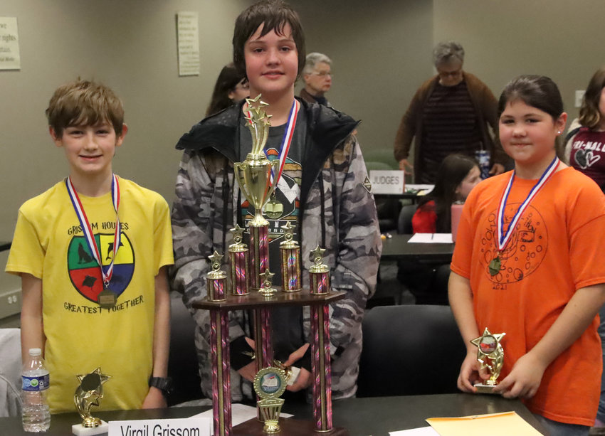 Virgil Grissom students pose with their medals and trophies. From left: Fin DeBourcy, Colin Luckritz and Bella Burkle.