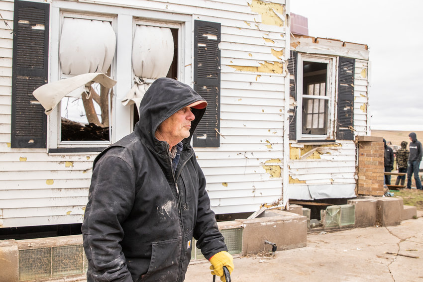 Bill Norton stands outside of his family home  on Saturday, April 1