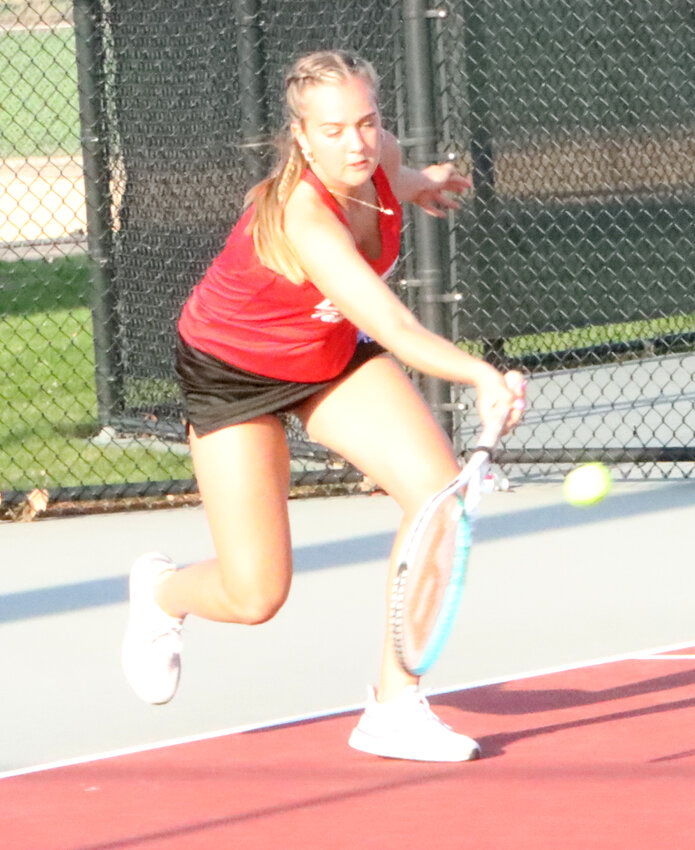 Lancer senior Ella Kuesel digs a ball out during the first set of her doubles match with Olive Khoury on Friday.