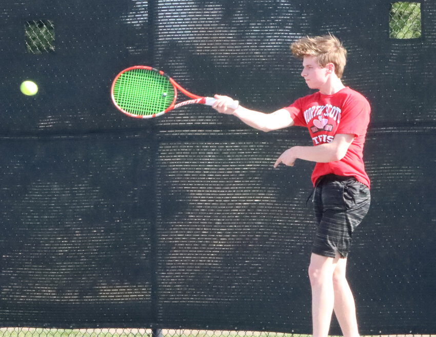 Junior Tristan Moore follows through on a forehand Tuesday afternoon.