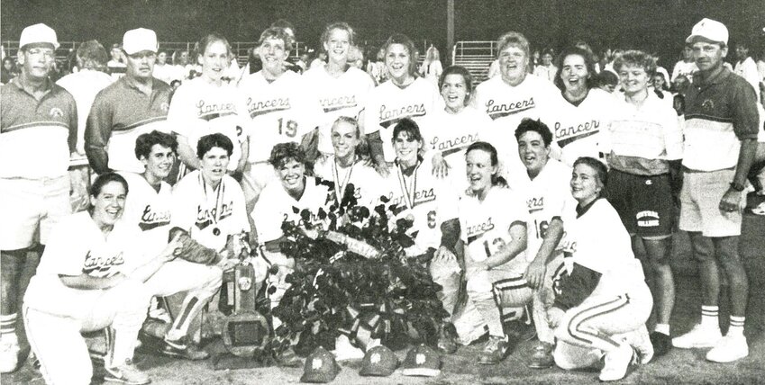 The 1993 state championship softball team included, front (l-r): Shannon Hans, Lisa Holden, Lea Twigg, Sara Kirby, Lori Osterberg, Christy Dalton, Jill Hyer, Heather Gress and Heather Taylor. Back: Asst. coach Bob Rhinehart, assistant coach Dave Vens, Tara Buzzell, Carrie Gronewold, Jenny Schneckloth, Melissa Towers, Angela Loesel, Kerri Brehmer, Amber Pewe, assistant coach Heather Reedy, and head coach Dennis Johnson.