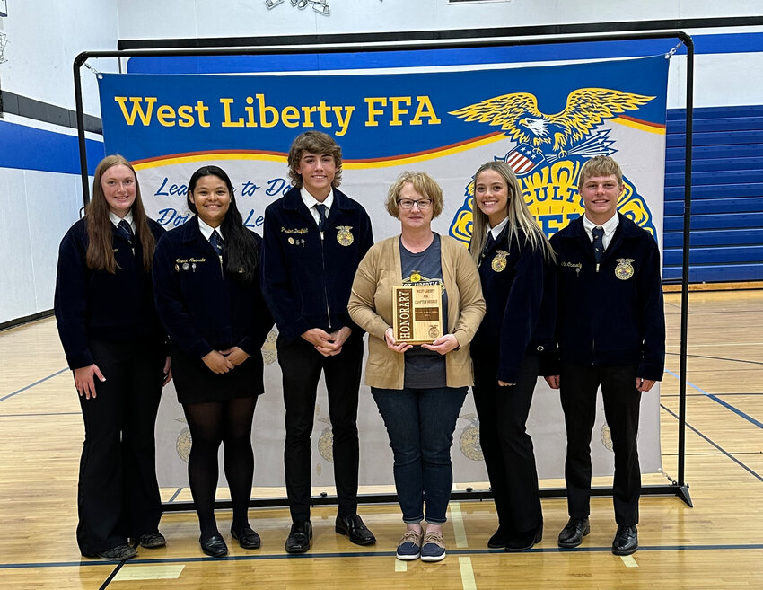 Pictured from left are Addyson Lehman, Amerie Alvarado, Preston Daufeldt, West Liberty High School Principal Brenda Arthur-MIller, Brooklyn Buysse and Collin Cassady during the FFA Awards Banquest last week. Arthur-Miller was inducted as an &quot;honorary member&quot; and celebrated for her state award.