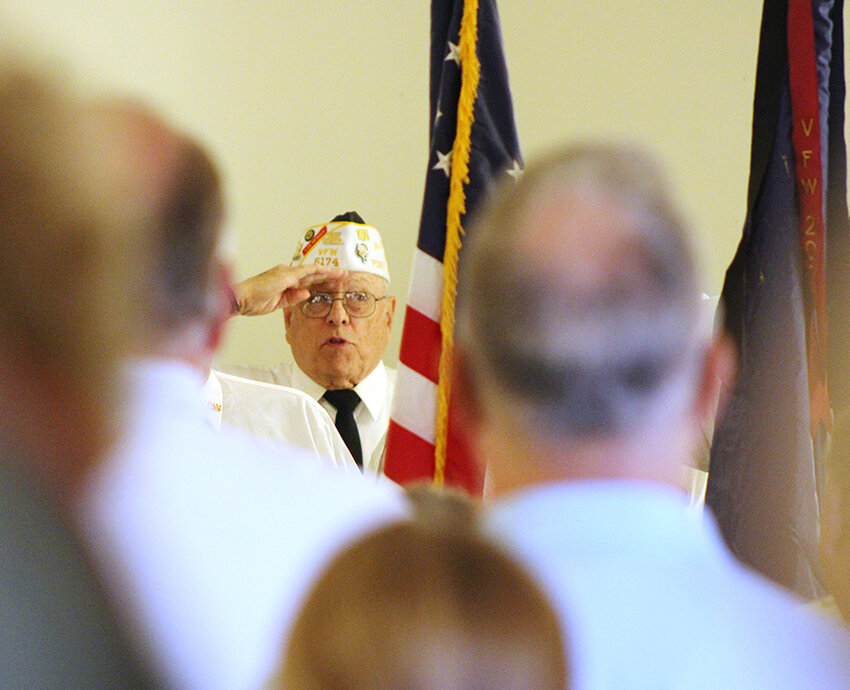 Duane Miller of the Eldridge VFW salutes the American flag during the presentation of the colors.