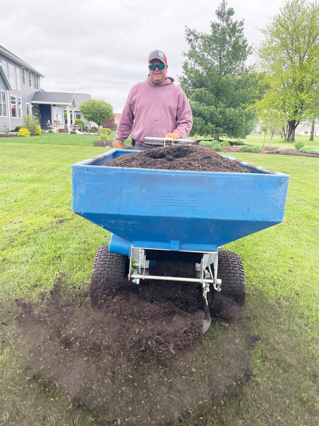 Brian Wood treats an Eldridge lawn with compost through a government-subsidized program that covers half of homeowners' costs.