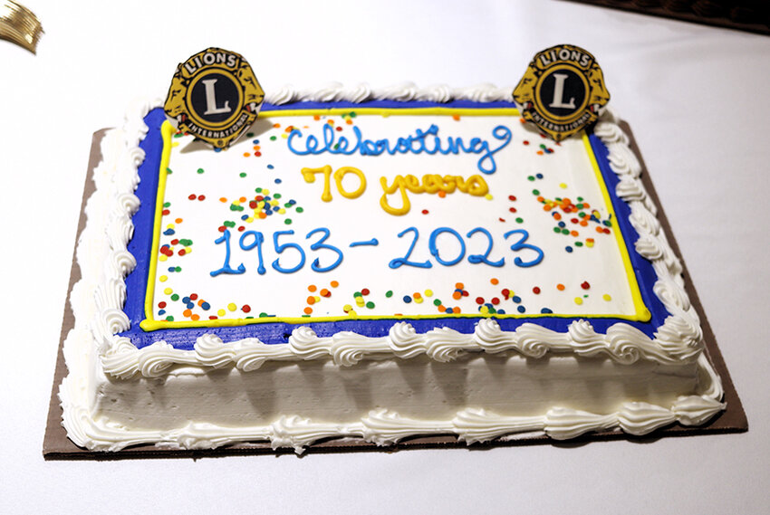 Eldridge Lions Club members cut this cake June 24 at their celebration at the Eldridge Community Center.