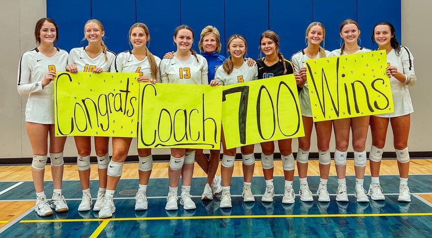 Wilton volleyball coach Brenda Grunder won career match No. 700 last Tuesday at the Wapello volleyball tournament. Grunder has led seven Wilton teams to the state tournament and won ten conference championships over her career. From left: Samantha Daufeldt, Kinsey Drake, Kaydence Boorn, Calli Langley, Brenda Grunder, Jessica Clark, Annie Holladay, Ali Walker, Lilly Kraft, and Leah Caffery.