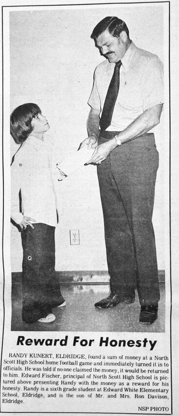 1973: North Scott High School principal Edward Fischer rewards sixth-grader Randy Kunert, of Eldridge, for returning cash he found at a football game.