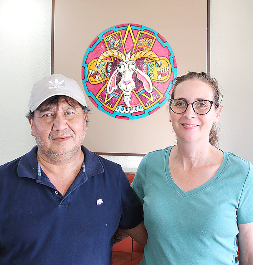 Standing before their &ldquo;Crazy Goat&rdquo; logo, La Chiva Loka owners Jose and Karen Cabrera take a moment inside their new West Liberty restaurant that opened Friday.