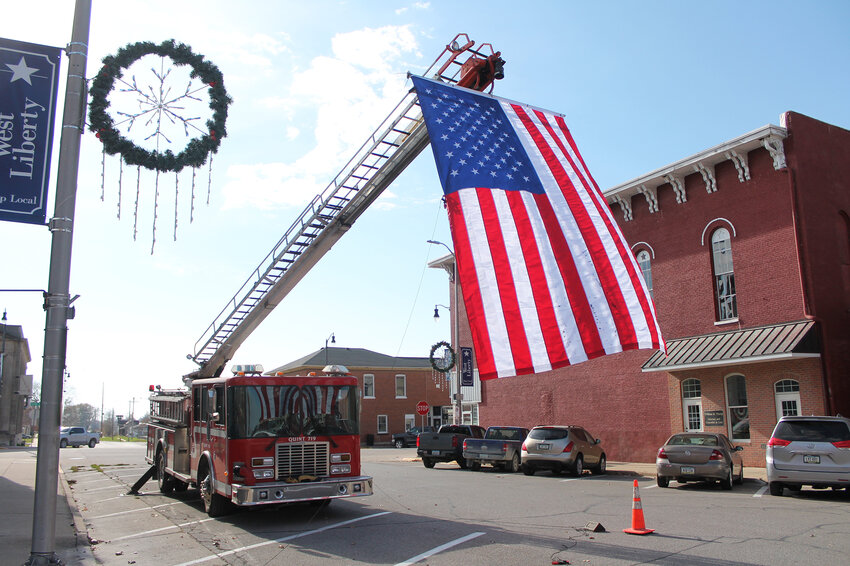 The West Liberty Fire Department hung a huge flag over Calhoun Street in front of the American Legion Building on Saturday, Nov. 11, for Veterans Day.