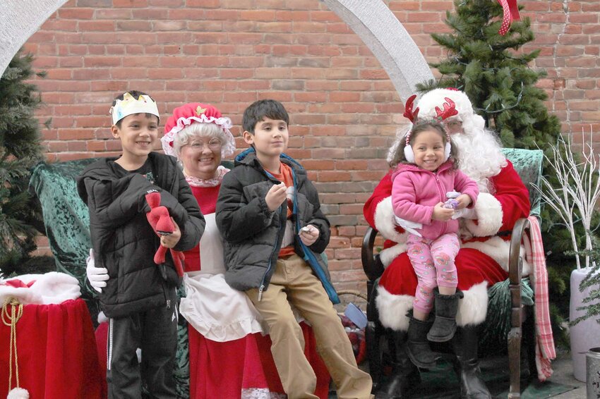 Gael and Oscar Maldonado and Amilah Kelly visited Santa Claus and Mrs. Claus during the West Liberty Chamber&rsquo;s Open House on Sunday, Nov. 19 / Photo by Jacob Lane