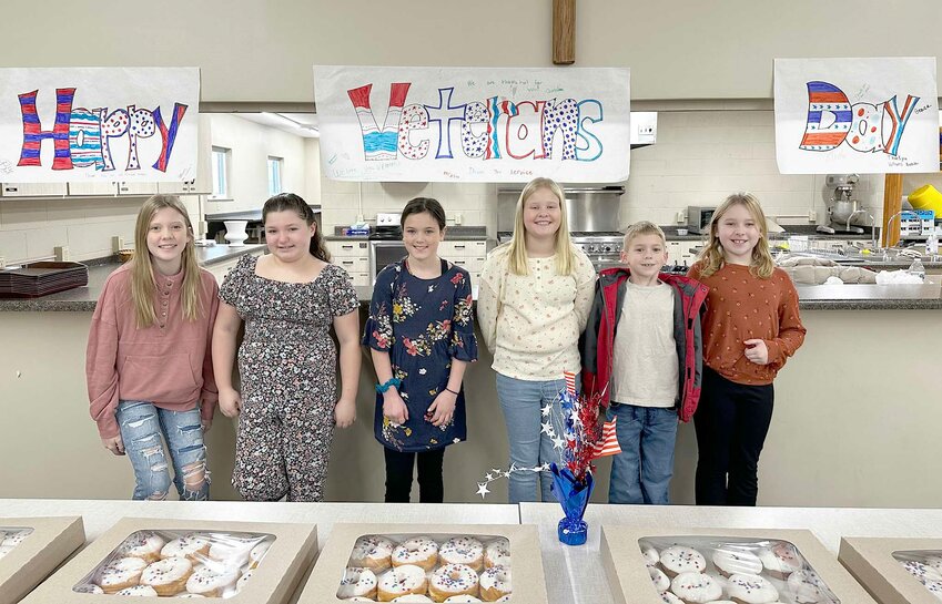 St. Mary's kids serve red, white and blue donuts to veterans.