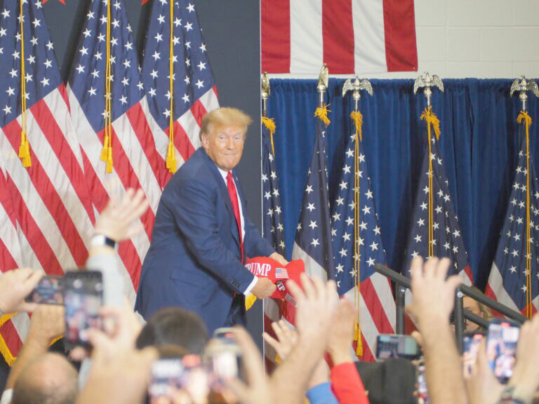 Donald Trump throws hats into the crowd during his campaign rally at Kirkwood Community College in Cedar Rapids Dec. 2.
