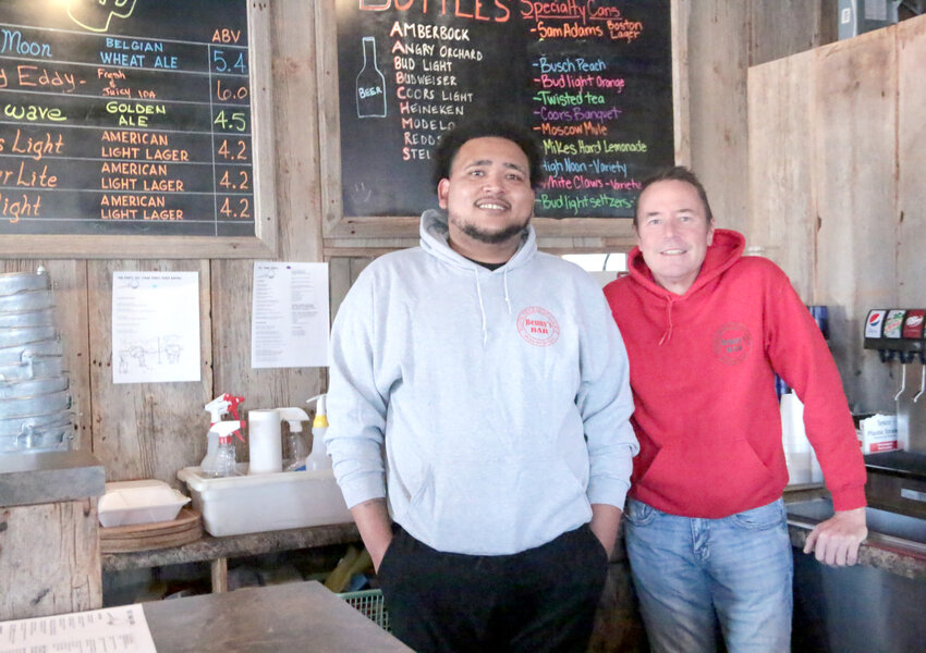 Austin Gray, left, and Rustic Ridge owner Heath Christians pose outside the Tee Time Grille kitchen.