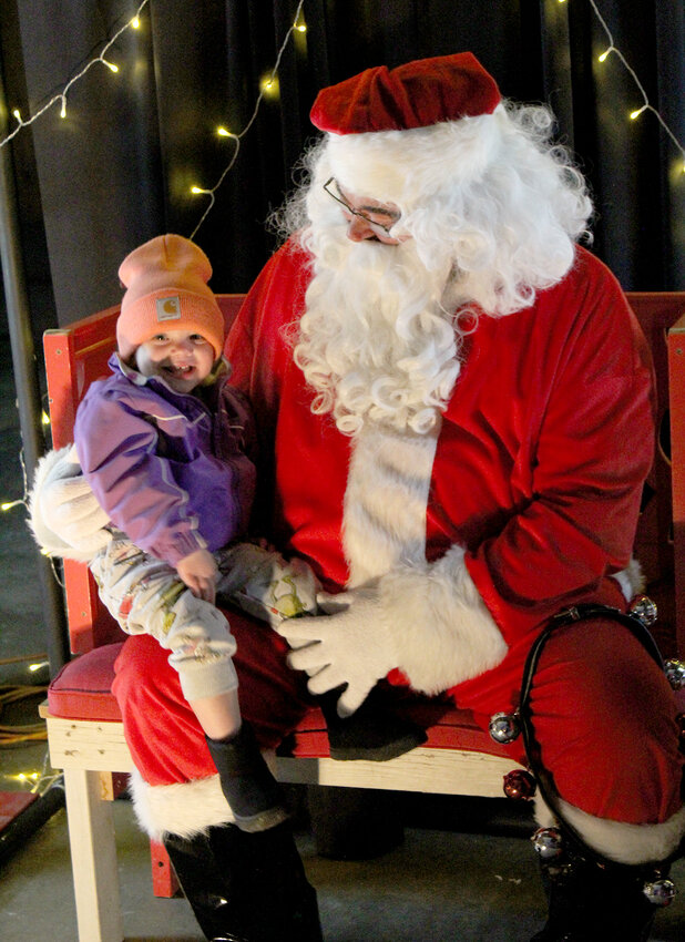 Kynlee Gephart, 1, was excited to meet Santa Claus during Wilton&rsquo;s Window Walk on Sunday, Dec. 3, organized by the Wilton Chamber and Development Alliance / Photo by Jacob Lane