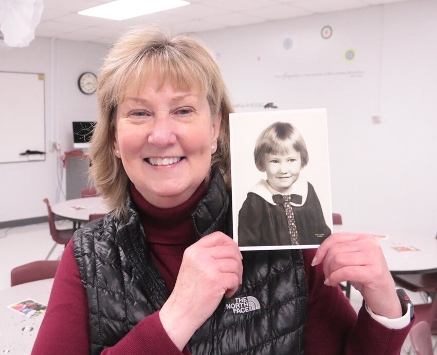 Christie Liske poses with her kindergarten photo during her retirement reception, Friday at Glenn Elementary.