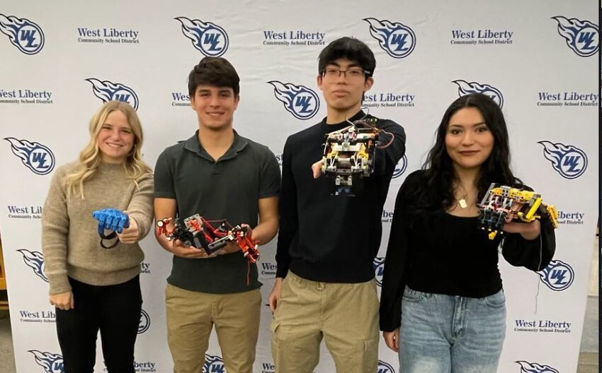 Pearson Hall, Bryson Garcia, Eric Yao and Betsy Bejarano with Lego prostetic hands