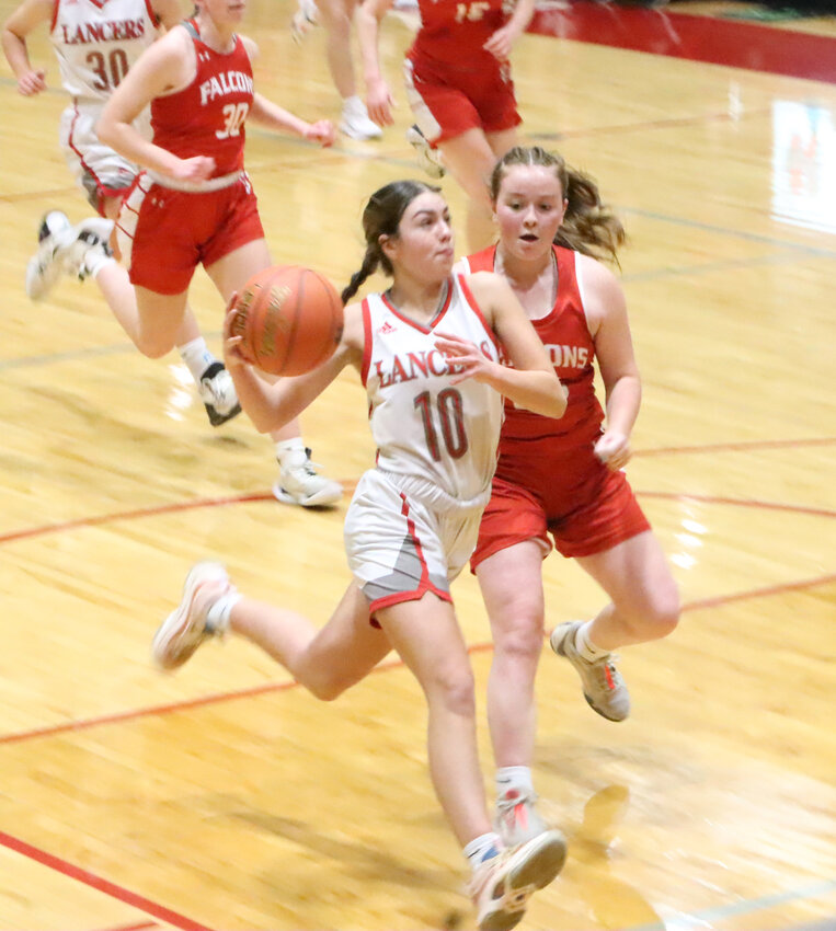 Junior Bella Mohr races to the basket and beats her Falcon defender.