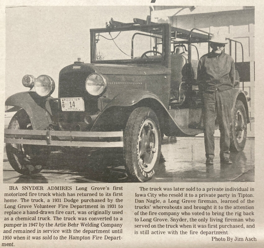 Ira Snyder poses next to Long Grove's first fire truck. Long Grove fireman Dan Nagle found the old truck in Tipton, and helped bring it back to town. Snyder joined the Long Grove department when the truck was in use.