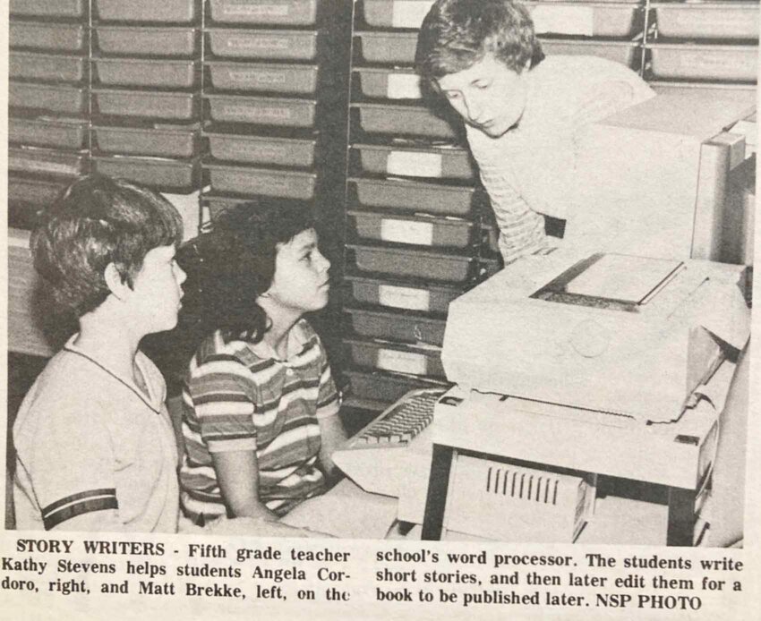 Fifth-grade teacher Kathy Stevens helps students Angela Cororo, and Matt Brekke on the school&rsquo;s word processor.