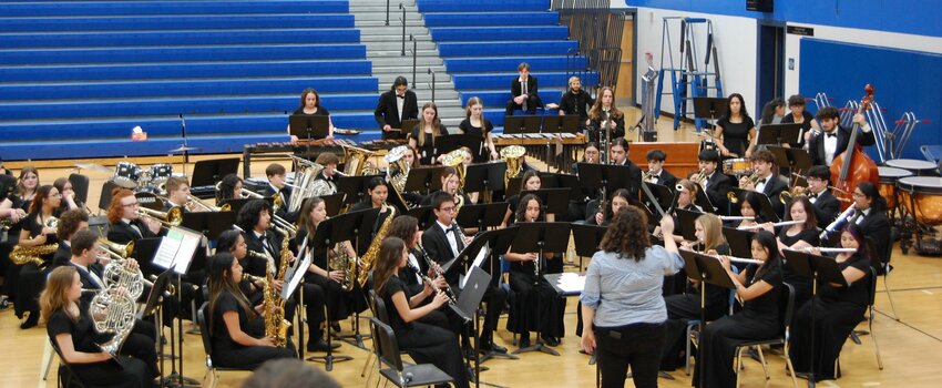Ashley Smith leads the high school wind ensemble as the evening&rsquo;s closing act. Photos by Stephanie Vallez