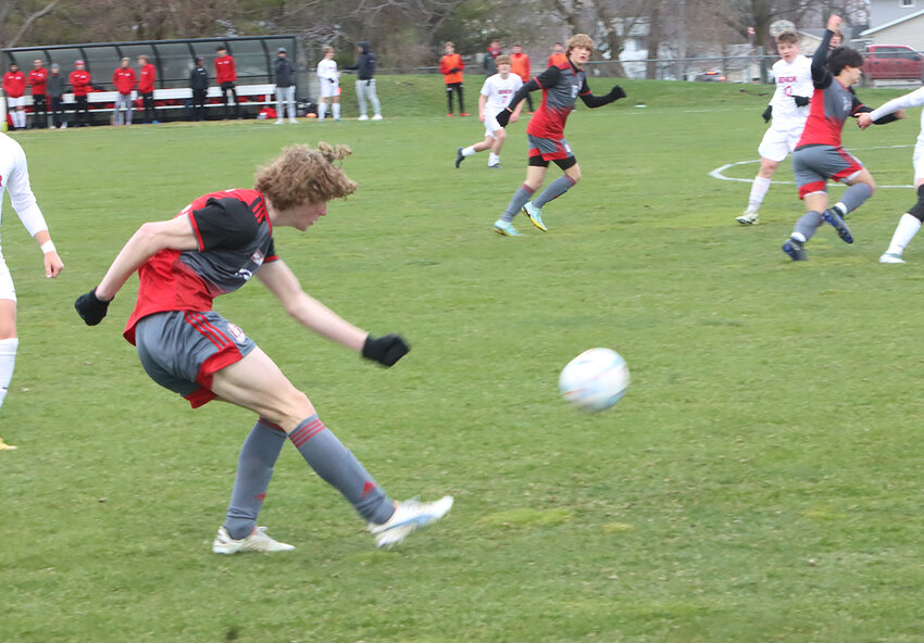 Sophomore Russell Squires blasts the ball up the field in the season opener against Dubuque Senior.