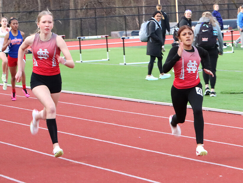 Freshmen Sophia Schneckloth (left) and Olivia Graham (right) take off and score points during the 400 meter dash.