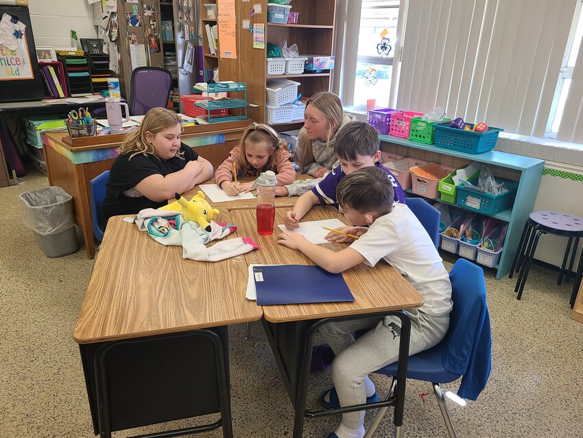 Sophomore &ldquo;big buddy&rdquo; Ava Streeter helps a number of students in Trisha Bullard&rsquo;s second grade classroom before working with her &ldquo;Little buddy.&rdquo;
