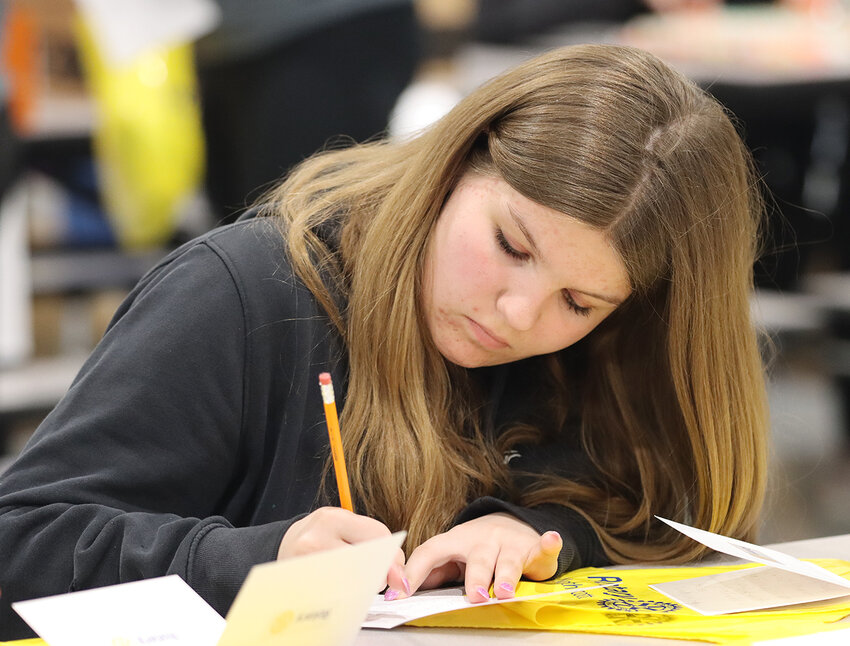Students, including Haylee Benthin, write notes of gratitude to first responders.