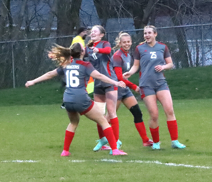 Senior Brooklyn Bullock (#11) leaps into the arms of sophomore Kenzie Moeller (#16) with teammates sophomore Paige Coon (#25) and senior Eva Hulscher (#14) ready to celebrate Bullock's 36th minute goal.
