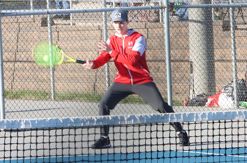 Junior Kellan Wenck gets a return back in play during his doubles match Friday afternoon at Pleasant Valley.
