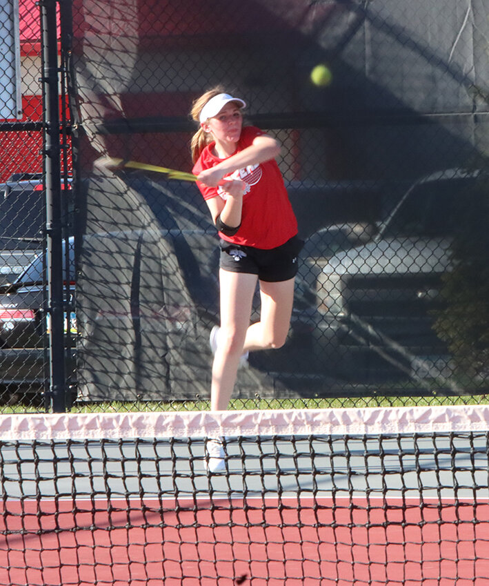 Freshman Maddy Jepsen punches this backhand across the court.