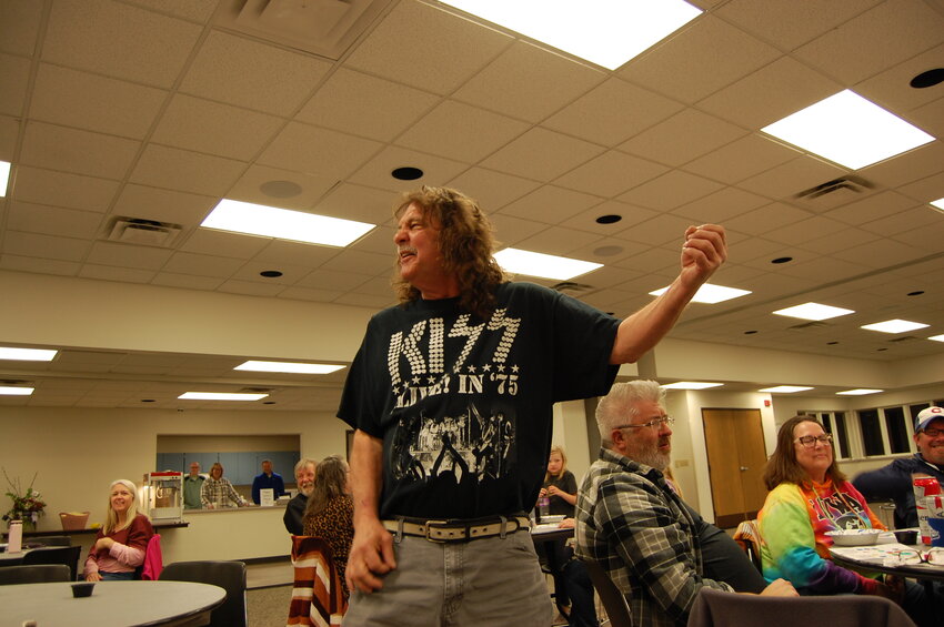 Tom (Dog) Christensen demonstrates his wicked air guitar skills during Music Bingo at the West Liberty Community Center, a fundraiser benefitting the West Liberty Child Care Center