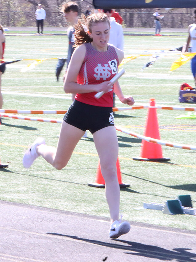 Running bright and early, senior Sydney Skarich caps off the sprint medley at Bettendorf.