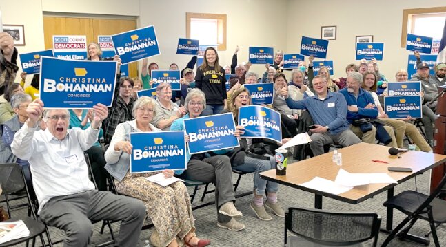 Scott County Democrats pose before canvassing for congressional candidate Christina Bohannan, center.