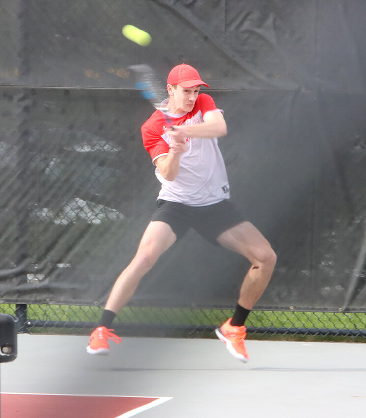 Sophomore Lucas Persson flicks this backhand right back to Bettendorf's Robert Matera during their singles match on Monday, April 22.