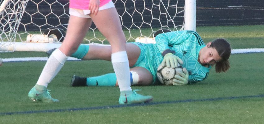 Freshman goalkeeper Nora Barnett makes a diving stop during the first half of last Tuesday's game at Brady Street Stadium.