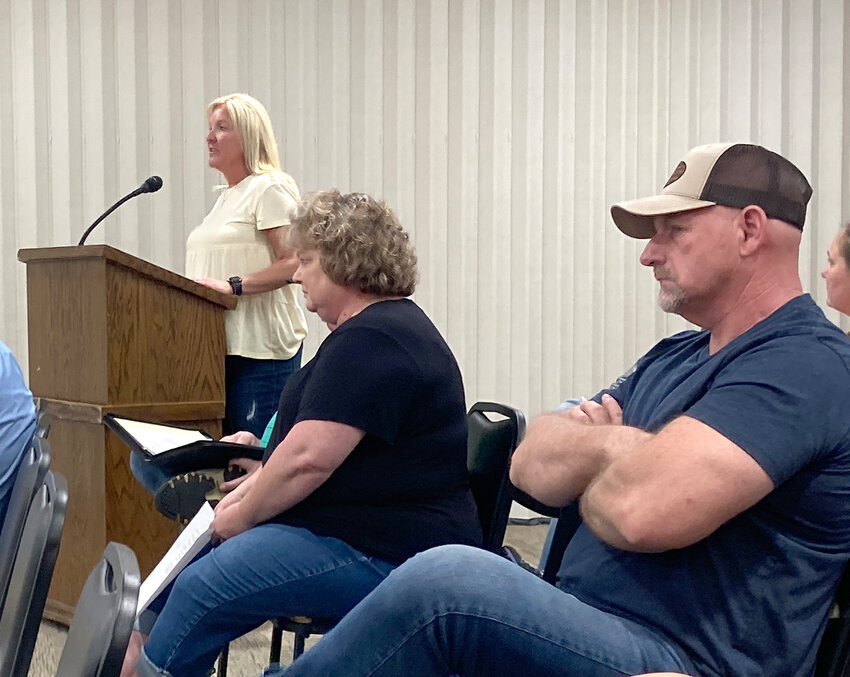 Paula Steward speaks to the Eldridge council Monday night. Utility clerk Jody Coffman, right, was among more than a dozen of her supporters.