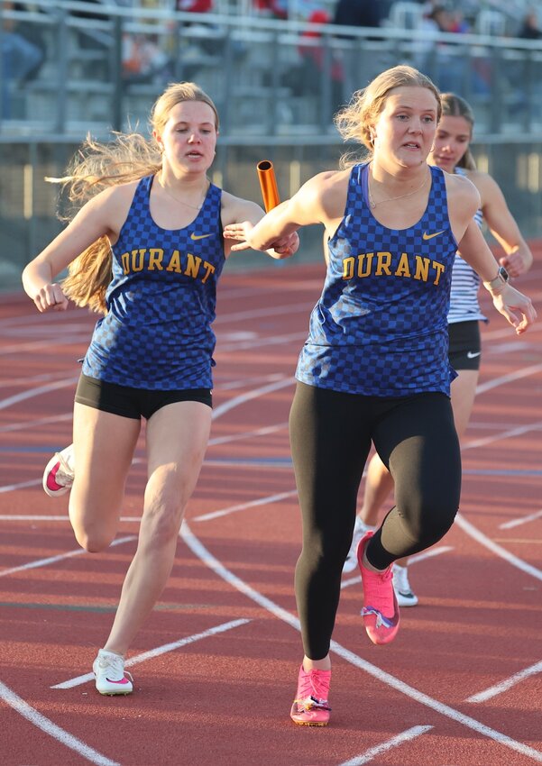 Ally Meincke hands the baton to her older sister Emma during the 4x200 relay