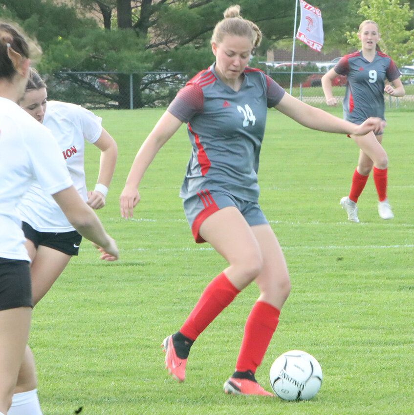 Senior defender Bella Steiner shields the ball during last Tuesday's marquee matchup with Davenport Assumption.
