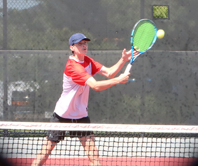 Senior Drew Norris puts away a volley on day two of the MAC championships.