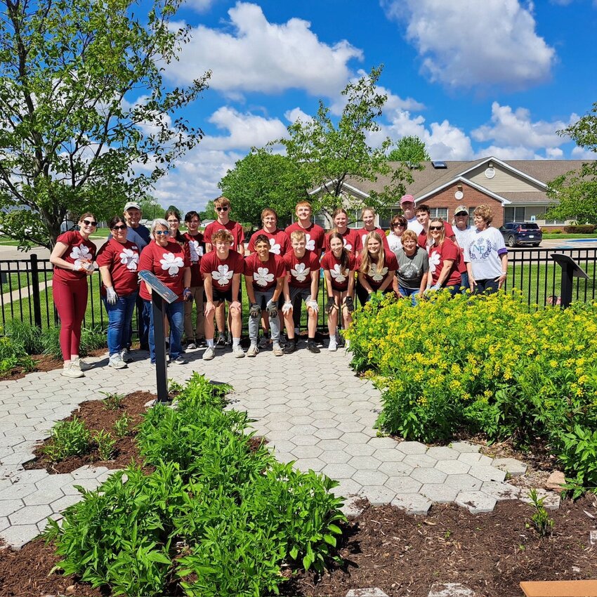 High school students teamed up with CBI Bank &amp; Trust employees to help clean the library reading garden during United Way&rsquo;s Day of Caring on Friday, May 10