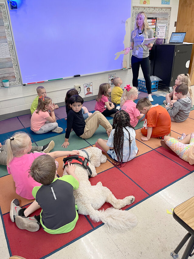 Yadi lays quietly among students as kindergarten teacher Kara Hamann gives a lesson in her Walcott classroom.