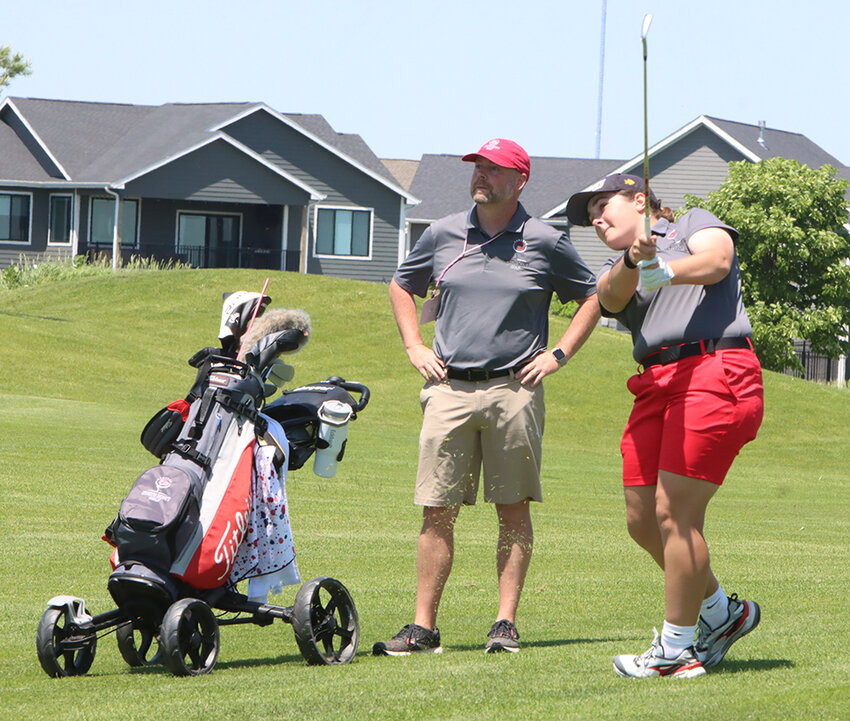 Sophomore Addison Eckhardt and Lancer coach Zeb Hubner watch this shot on the seventh hole fly.