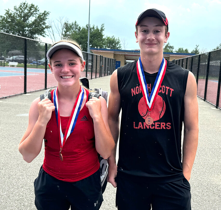 Freshman Maddy Jepsen (left) and sophomore Lucas Persson (right) smile with their medals after a long day's work.