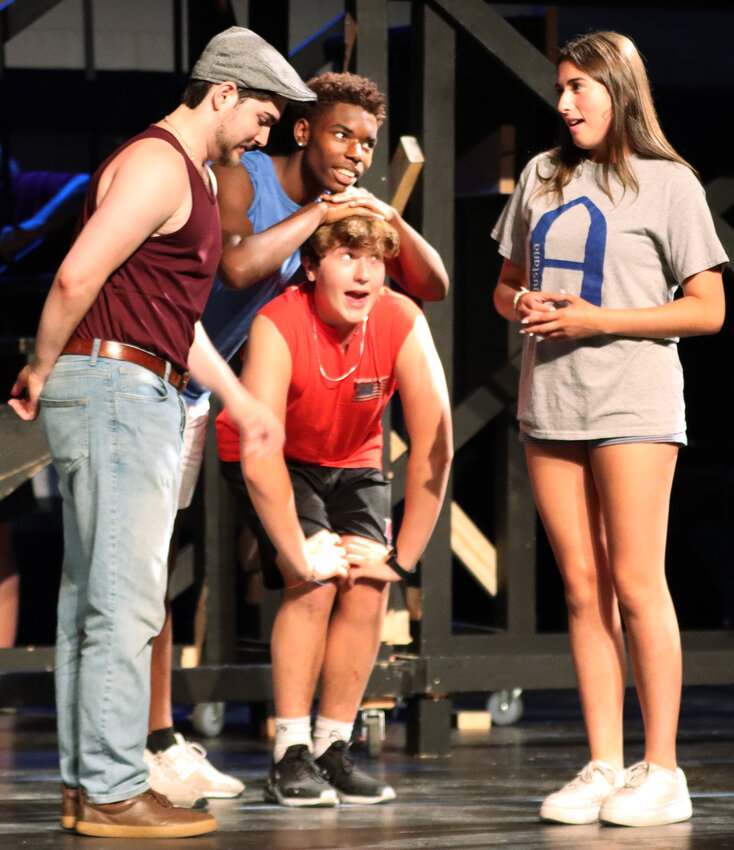 Benny (Keith Wright) and Sonny (Micah Roldan) watch as Usnavi (Jacob Johnson) attempts to ask Vanessa (Mia Roldan) on a date.